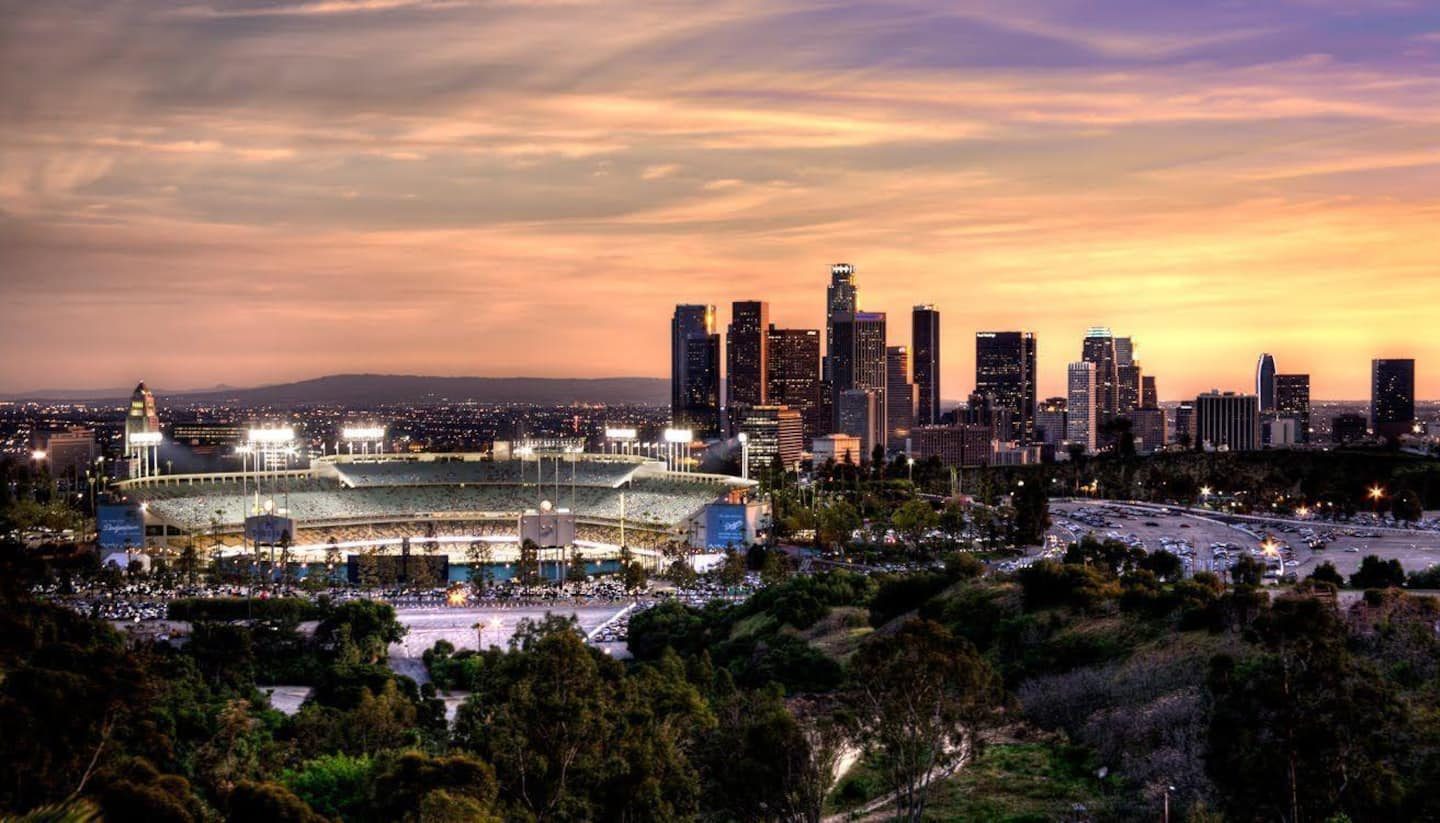 Dodger Stadium and the downtown skyline at sunset, seen from the hills