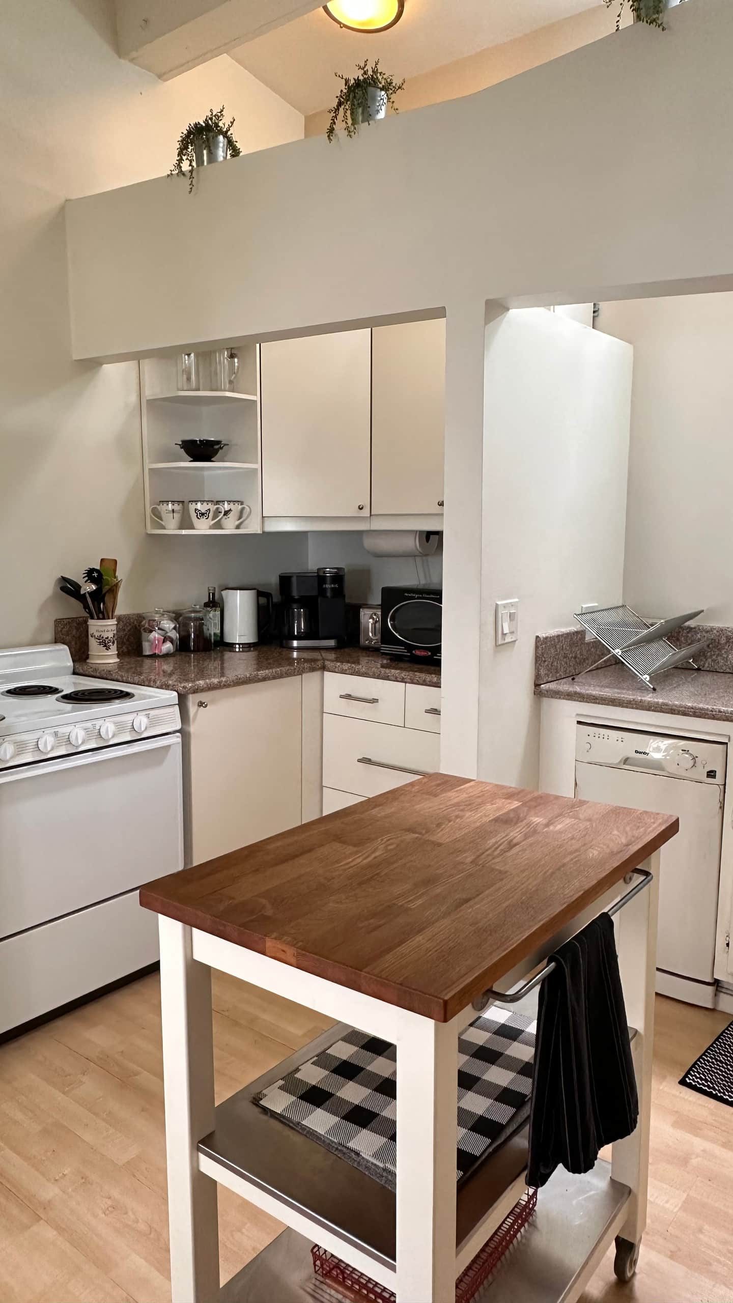 Studio kitchen with butcher block island and full sized appliances
