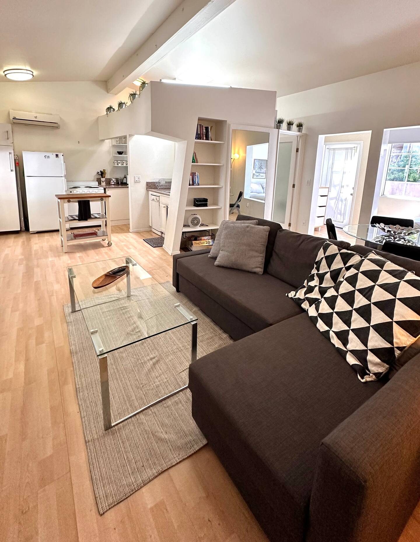 The studio living area under the vaulted ceiling, sectional sofa and skylight