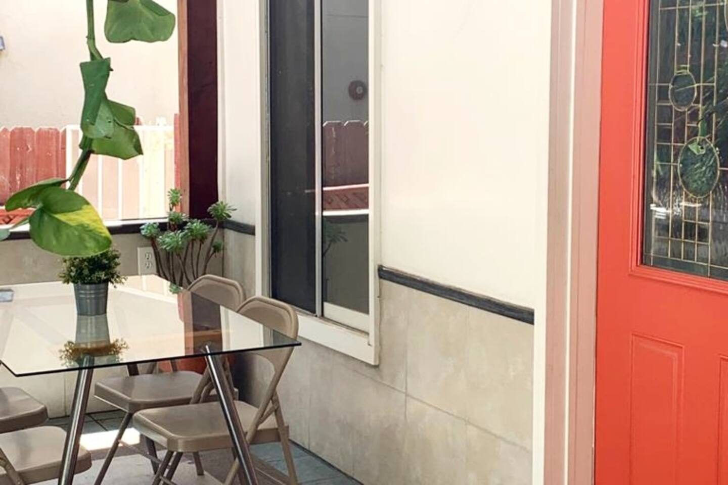 Glass table on the covered patio beside the stained glass door